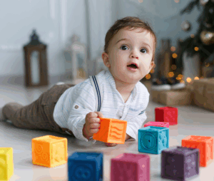 Baby playing with coloured stacking blocks